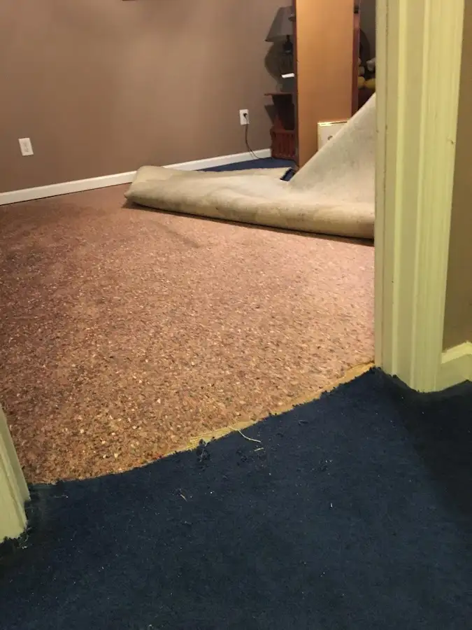 Carpet pad removal revealing water damage during Water Mitigation Services in Snellville